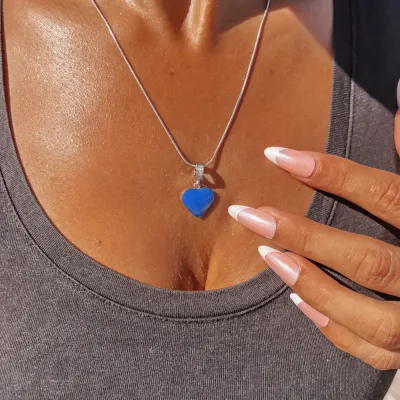 charm souvenir connecté argenté et résiné bleu porté par une femme